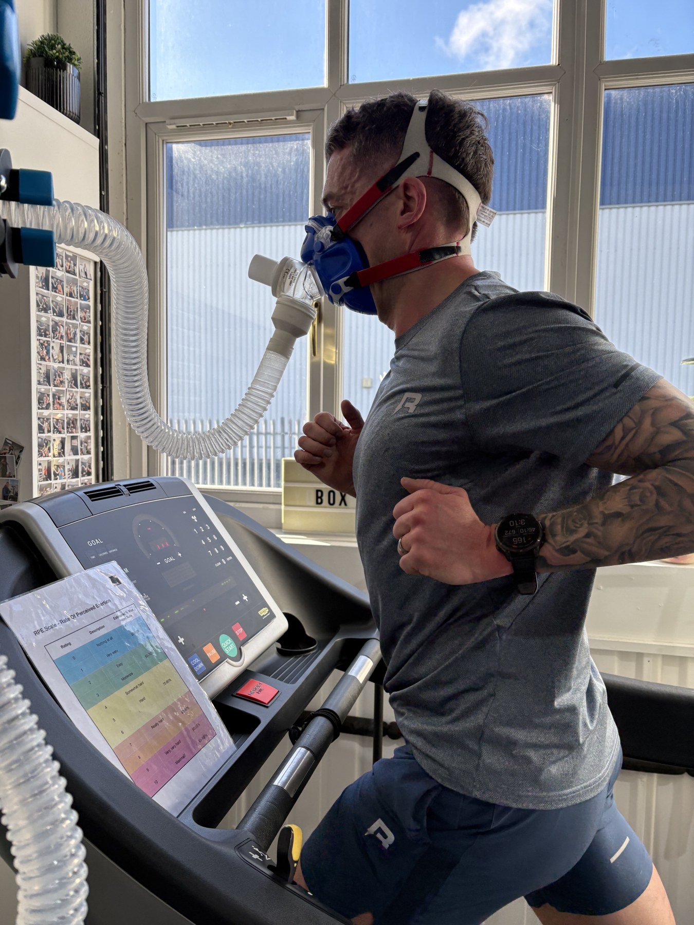 Close-up of an athlete running on the treadmill wearing a VO2max mask during lab testing